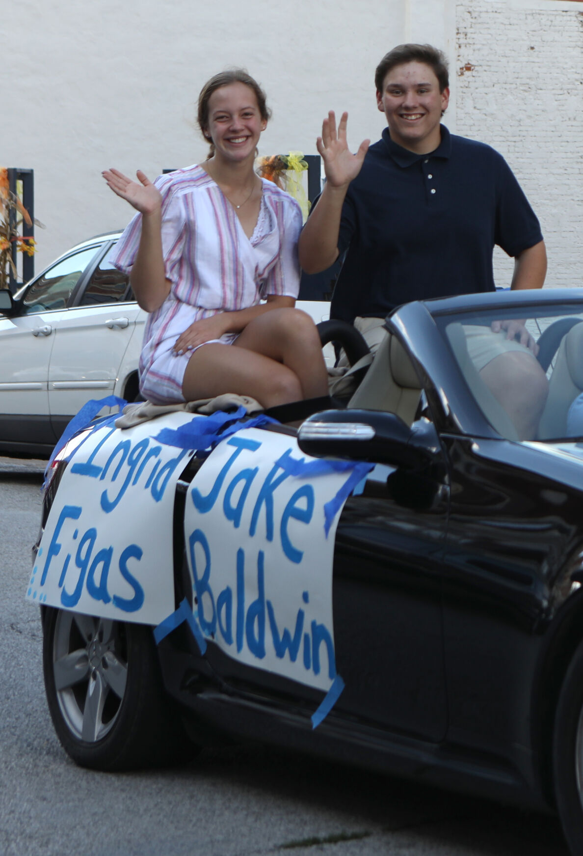 Ingrid Figas and Jake Baldwin wave